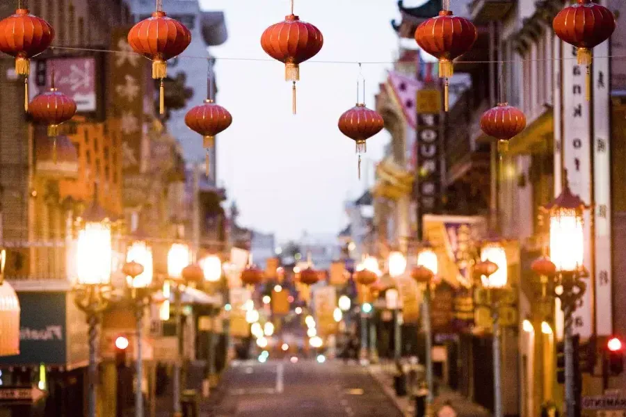 Close-up view of a string of red lanterns hanging above a street in Chinatown. San Francisco, California.